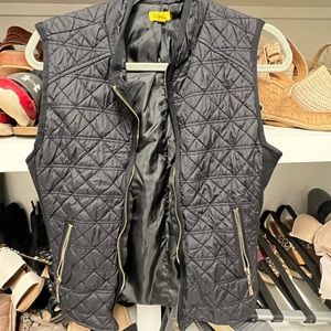 Black vest with gold zipper